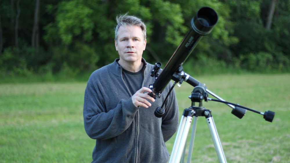 Brad Peterson with telescope on location during "what the open heart allows" music video film-shoot